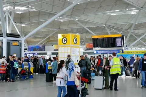 Passengers queuing in the departures hall at Stansted Airport